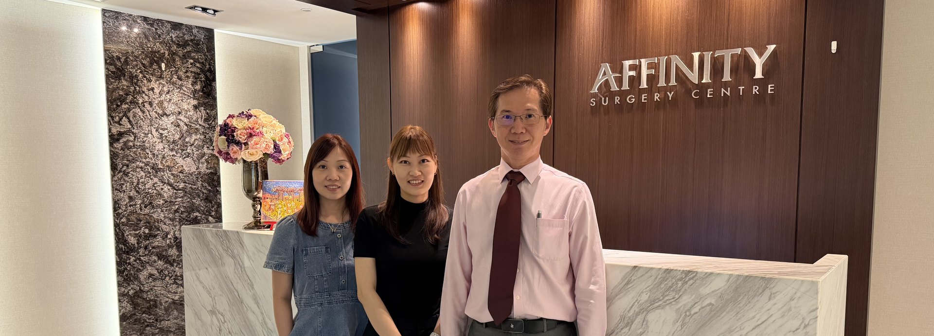 Dr Chen Chung Ming with two members of the Affinity Surgery team at the clinic reception.